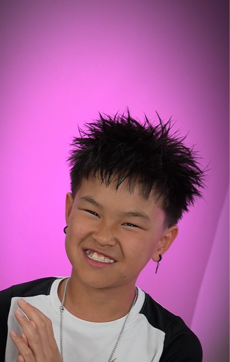 Young client smiling with a spiky textured cut