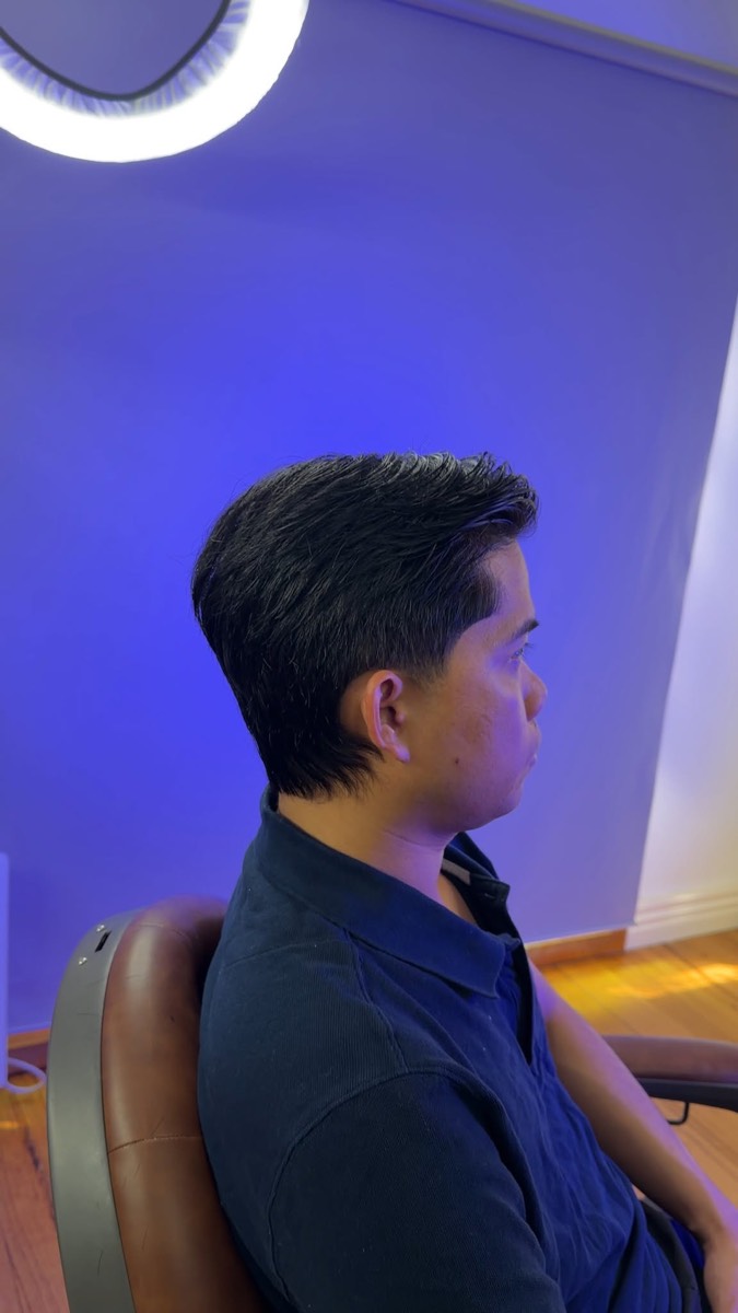 Classic scissor cut with a natural taper under blue light
