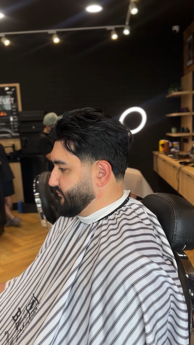 Skin fade blended into a full beard