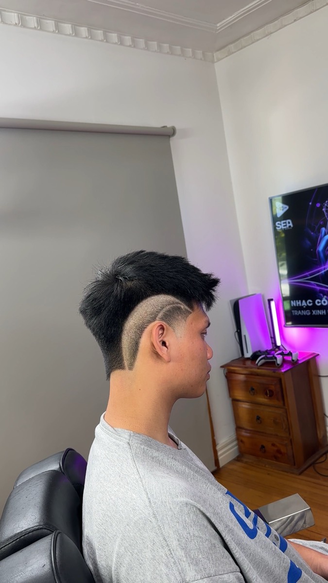 Fade with a curved hair tattoo design