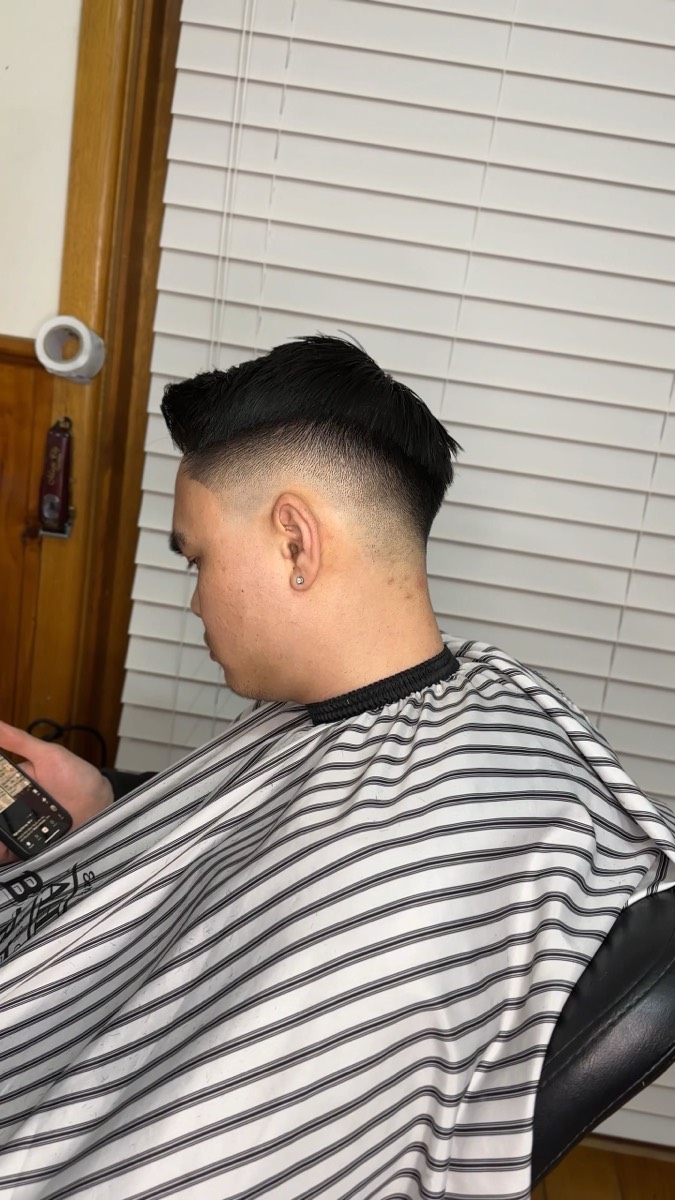 Mid fade with a swept-back textured top